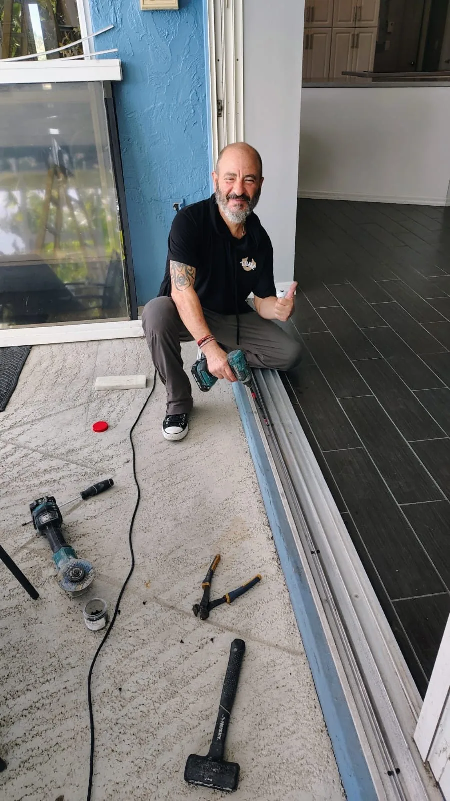 KayGE technician giving a thumbs up next to a freshly restored sliding door track